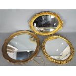 Three decorative wall mirrors, largest a