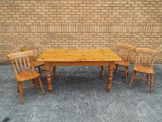 A rectangular topped pine kitchen table