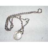 A silver necklace with coin pendant