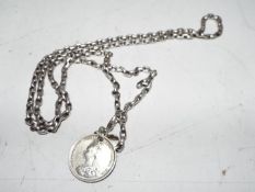 A silver necklace with coin pendant