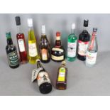 A collection of alcoholic drinks to include absinthe, sake, Grand Marnier, ouzo and similar,