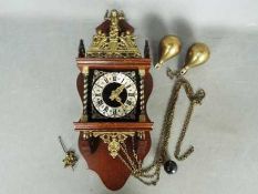 A Zaanse type wall clock with two weights and pendulum.