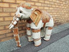 A Burmese ornately decorated articulated wooden elephant, from the Mandalay Puppet Theatre,