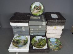 A quantity of boxed collector plates, three boxes.