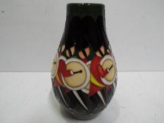 A Moorcroft ceramic vase decorated with twelve drummers drumming, approx 12.