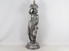 A large cast metal lamp in the form of a lady carrying baskets of fruit, approximately 80 cm (h).