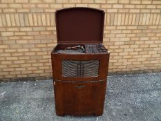 A floor standing Decca 100 Radiogram with Garrard turntable measuring approximately 93 cm x 63 cm x