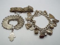 A silver charm bracelet with a quantity of white metal charms and two further white metal bracelets.