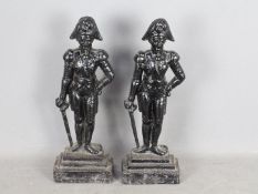 A pair of early 20th century cast iron door stops in the form of Napoleonic soldiers on stepped