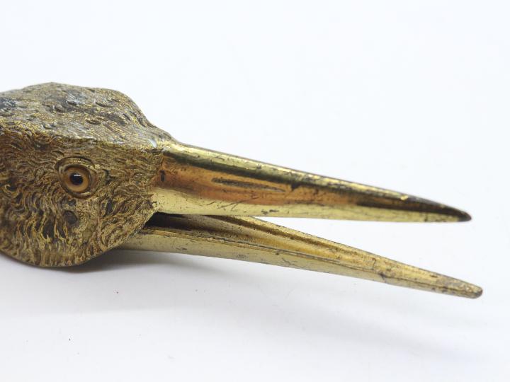 A late Victorian gilt metal paper clip in the form of a birds head, with glass eyes, - Image 4 of 4