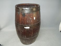 A good quality, oval section, coopered barrel, approximately 60 cm (h).