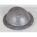 A Brodie type steel helmet with strap and liner, undated.