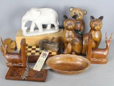 A collection of treen, animal carvings, chess set and a carved stone elephant.