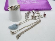 A silver chain, 46 cm (l) with five silver and stone set pendants,