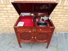 A twin door mahogany cabinet gramophone by Gilbert, approximately 82 cm x 83 cm x 52 cm.