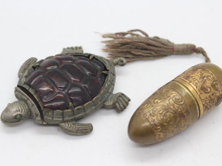 A late 19th or early 20th century white metal vesta case in the form of a turtle,