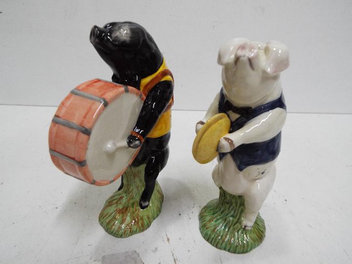 Two Beswick figures from the Pig band, approx 13 cm.