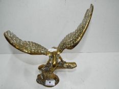 A brass figurine depicting an eagle, approx 29.