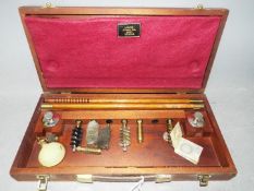 A vintage, wooden cased Lightwood gun cleaning kit.