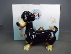 A boxed Pets With Personality model, Einstein The Dachshund, approximately 19 cm (h).