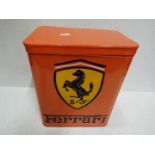A orange storage tin marked Ferrari,