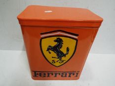 A orange storage tin marked Ferrari,