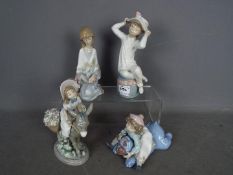 Four unboxed Lladro figurines, largest approximately 21 cm (h).