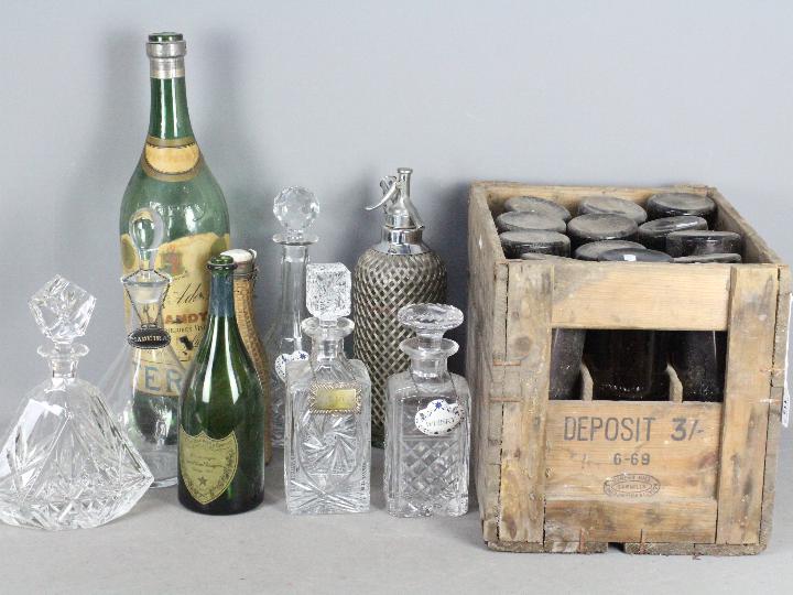 Lot to include decanters, bottle labels, vintage soda syphon, vintage bottles and other.