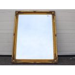 A large bevelled edge wall mirror, approximately 90 cm x 117 cm.