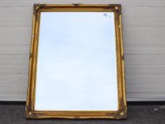 A large bevelled edge wall mirror, approximately 90 cm x 117 cm.