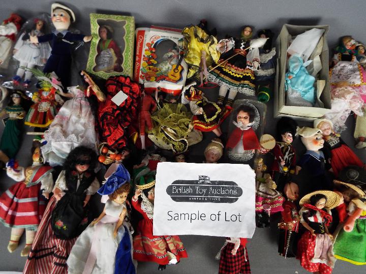 A box of international costume dolls and similar.