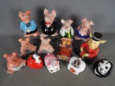 A collection of money banks to include Wade Natwest Pig examples.