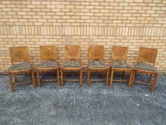 Six dining chairs with upholstered seats and walnut veneered backs.