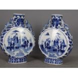 A pair of late 19th or early 20th century Chinese blue and white moon flasks raised on oval foot,