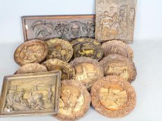 A collection of carved wooden wall plaques, black forest style and similar.