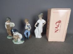 Nao - Four boxed figurines of children and animals, largest approximately 22 cm (h).