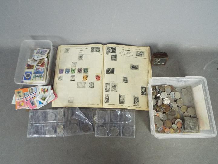 An All Nations Stamp Album containing a few stamps, a quantity of loose stamps,