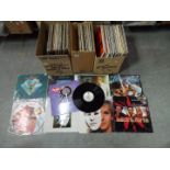 A collection of 12" vinyl records to include Peter Frampton, Johnny Cash, The Carpenters, The Doors,