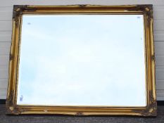 A large bevelled edge wall mirror, approximately 90 cm x 117 cm.