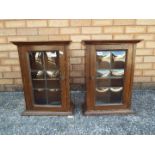 A small pair of cupboards with leaded glass doors, approximately 51 cm x 38 cm x 19 cm.