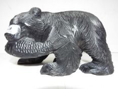 A carved wood Black Forest Bear with a Salmon in it's mouth approx height 17 cm (h)
