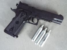 A Tanfoglio Witness 1911 Co2 .177 cal airgun, with three Co2 cartridges.