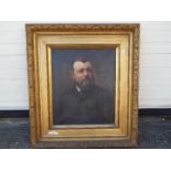 A large, late 19th or early 20th century framed oil on canvas portrait of a bearded gentleman,