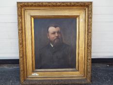 A large, late 19th or early 20th century framed oil on canvas portrait of a bearded gentleman,