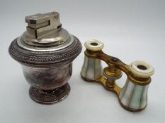 A pair of brass and mother of pearl opera glasses and a vintage Colibri table lighter.