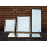 Four wall mirrors of varying size.