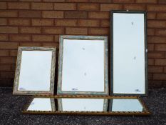 Four wall mirrors of varying size.