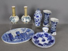 A quantity of blue and white ceramics to include ginger jar and cover, vases and similar.