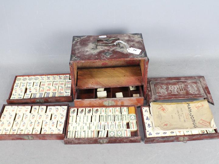 A vintage Mahjong set, wooden case with five drawers housing bone and bamboo tiles,