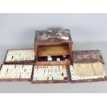 A vintage Mahjong set, wooden case with five drawers housing bone and bamboo tiles,
